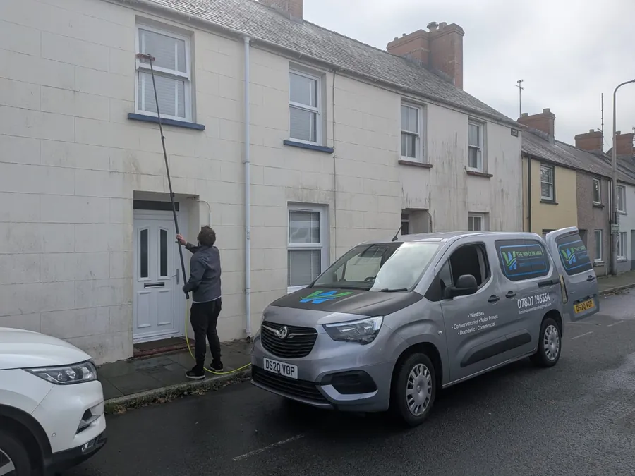 The Window Man van parked outside a terrace house during a clean