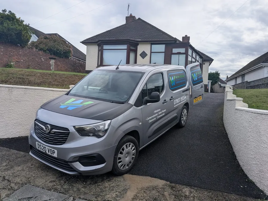 The Window Man van on a residential street during a job
